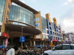 Orbit Mall building with glass facade and shops at ground level