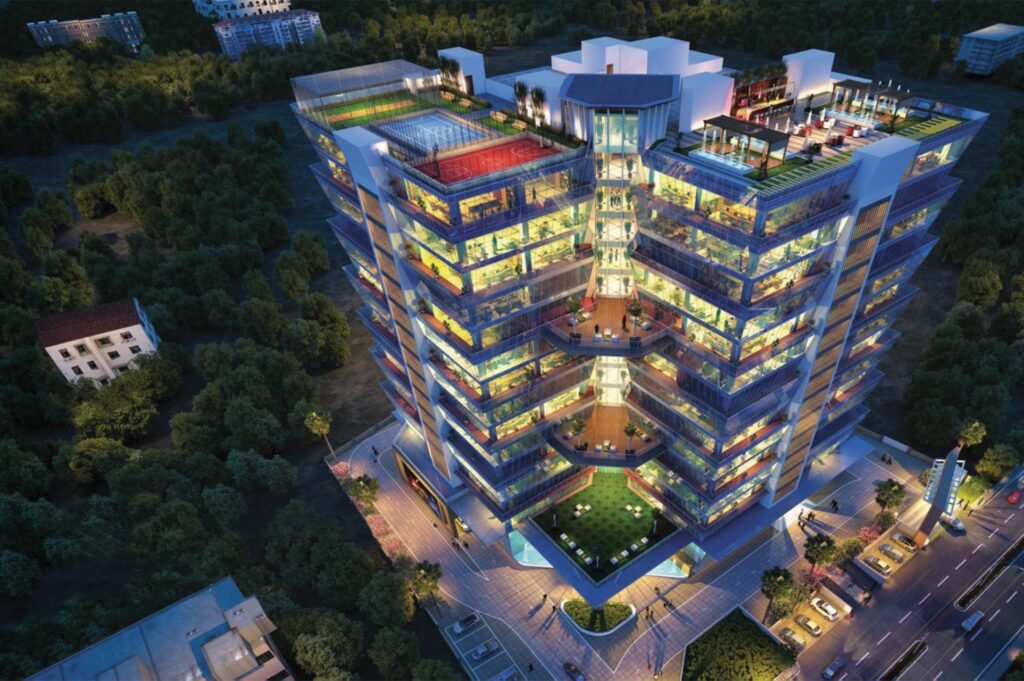 Night view of C21 Park commercial complex with modern glass architecture and rooftop amenities in Indore.